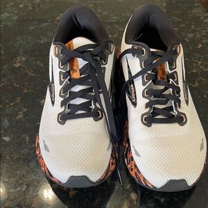 Brooks White Running Shoes with Black Laces and Orange Accents